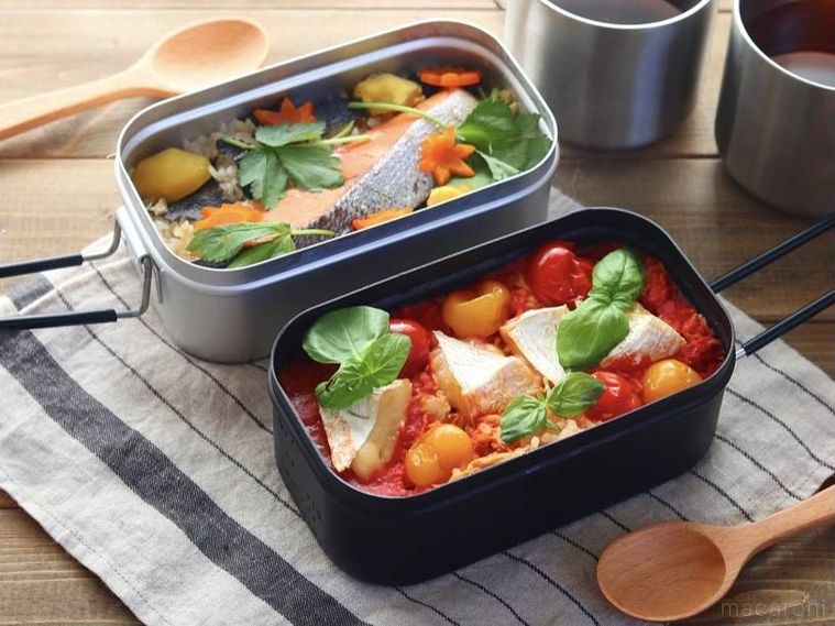 料理が入った2つのメスティンが机の上に置かれている