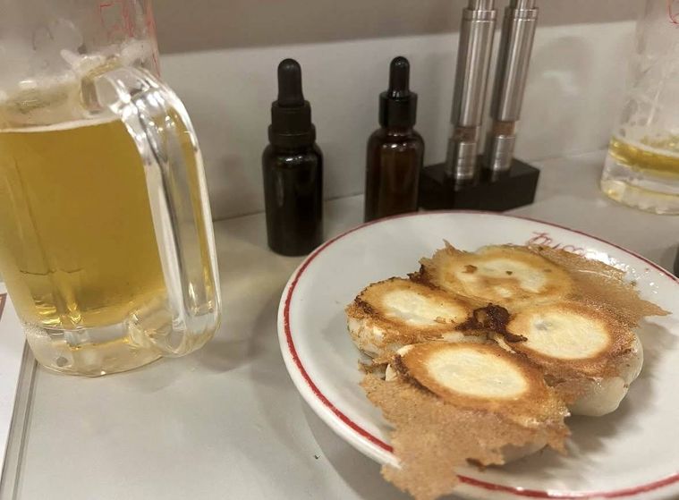 カウンターに置かれた羽根つき餃子とジョッキビール