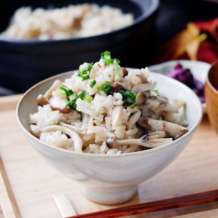 白い茶碗に盛りつけられた3種のきのこ入り炊き込みごはん