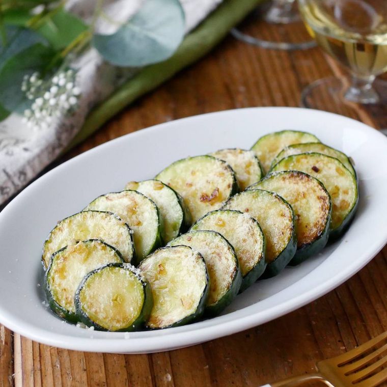 白い楕円形の皿に盛られたズッキーニのソテー