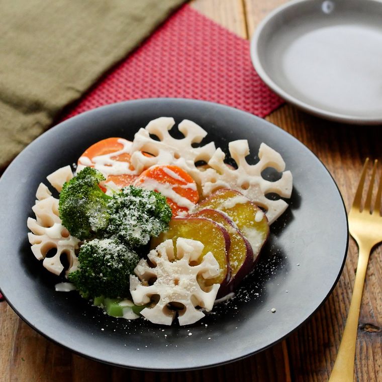 黒い円形の器に盛り付けられているフライパン蒸し野菜