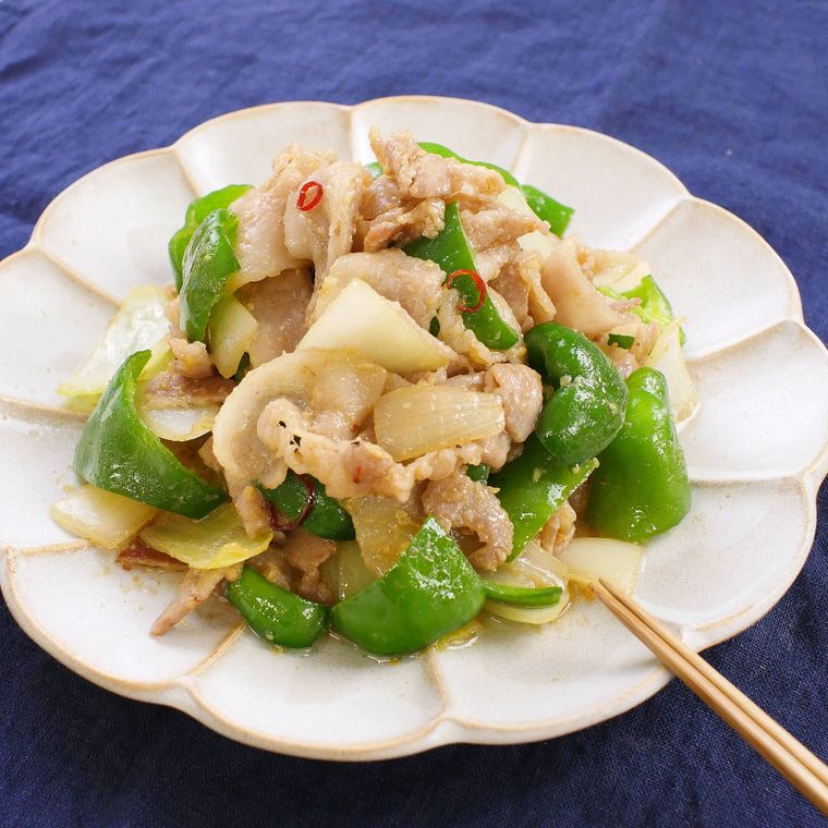 器に盛り付けた玉ねぎとピーマンの豚バラみそ炒めと箸