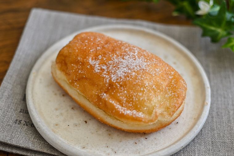 お皿にのったパンの田島のコッペ生ドーナツ カスタードクリーム