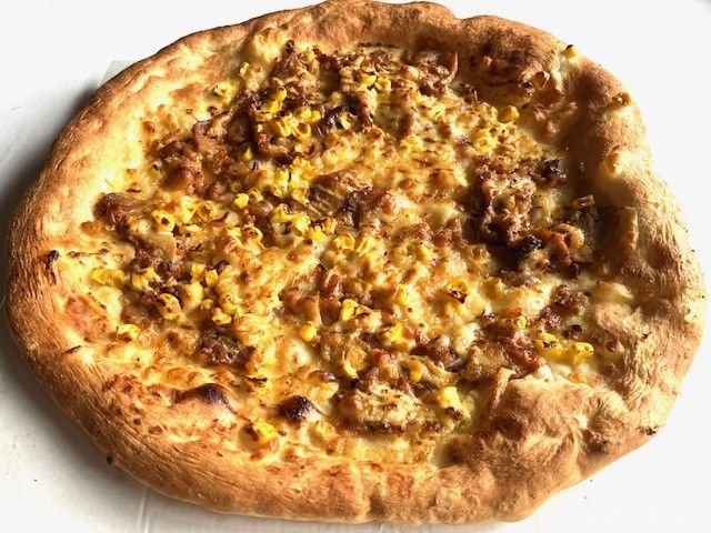 こんがり焼いたテリヤキチキンがのっているピザ