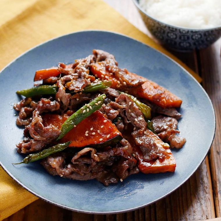 青い皿に盛り付けられた牛肉とかぼちゃの甘辛炒め