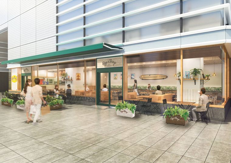 緑の屋根とガラス張りが特徴のパンケーキ店の外観