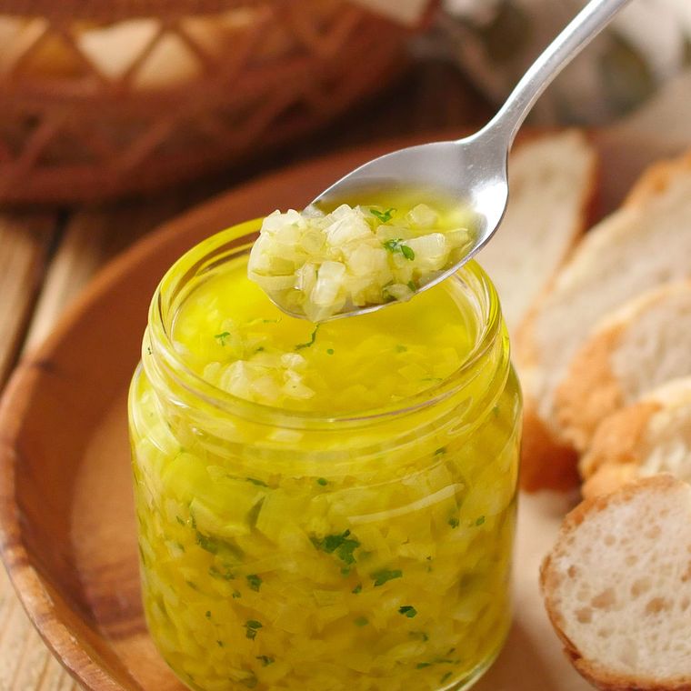 保存瓶に入ったソースアヒージョをスプーンですくう様子