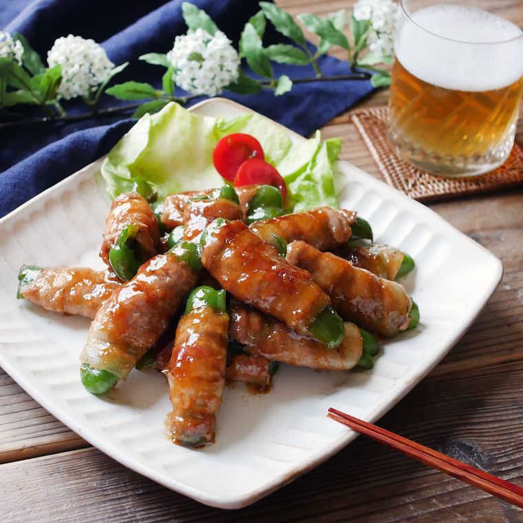 白色の四角の皿に盛られた肉巻きピーマンのしょうが焼き