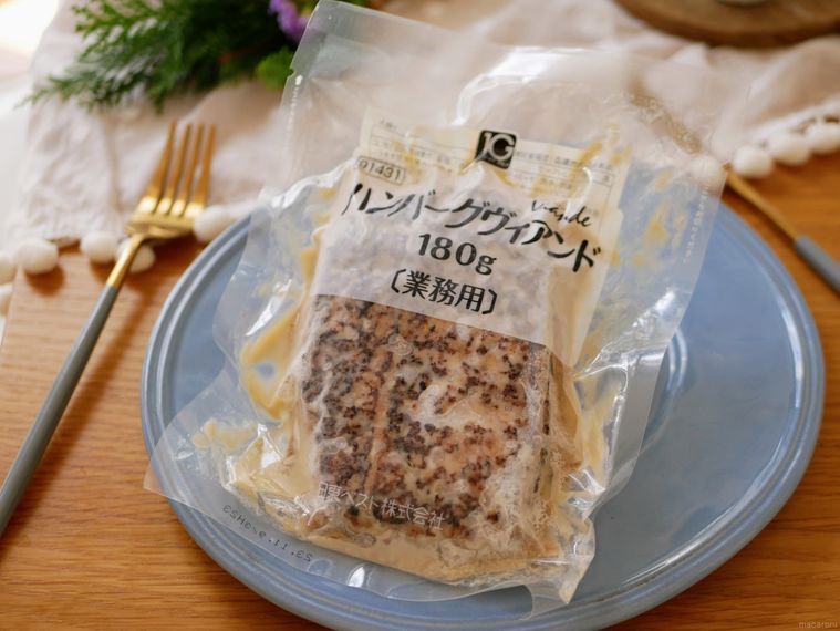 青い皿にのったオーケーストアの冷凍ハンバーグヴィアンドとカトラリーなど