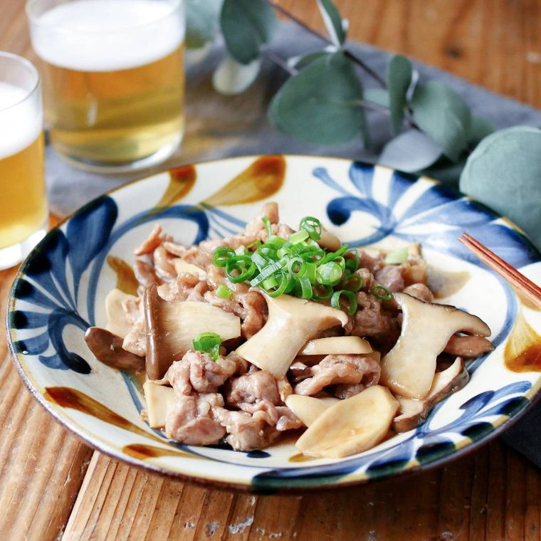 模様が入った丸皿に盛られた豚肉とエリンギのガーリックオイスター炒め