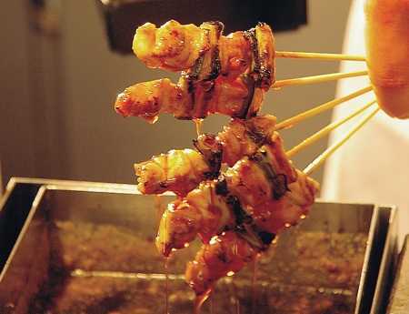 5本のねぎまを手で持っている