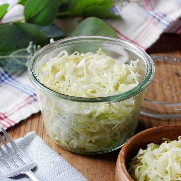 保存瓶と木の皿に入ったザワークラウト風