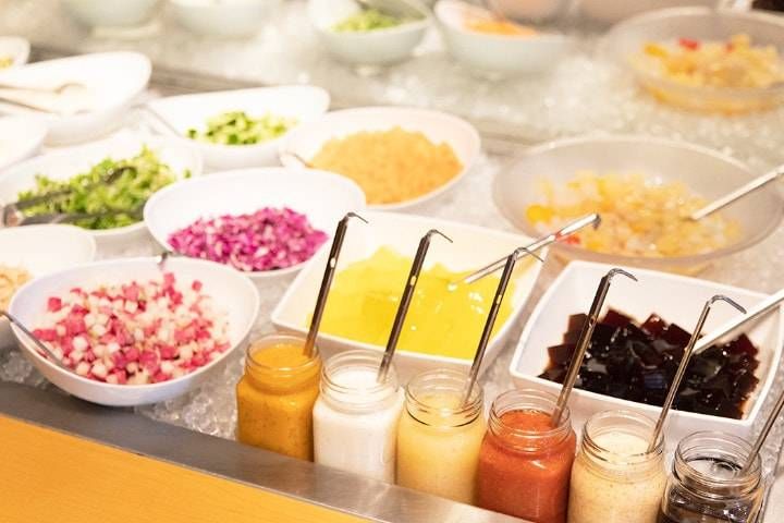 サラダバー用の野菜やドレッシングなどが並んでいる