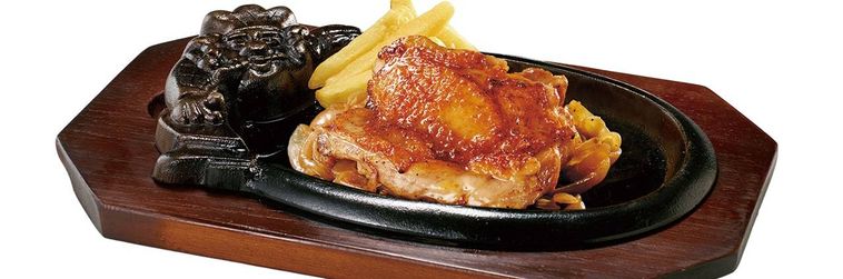 鉄板の上にチキンステーキとポテトがのっている