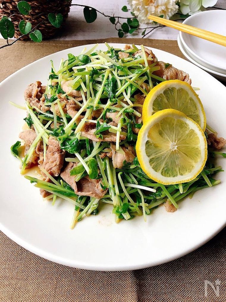 白いプレートに盛られた豚肉と豆苗のレモン醤油炒めと取り皿