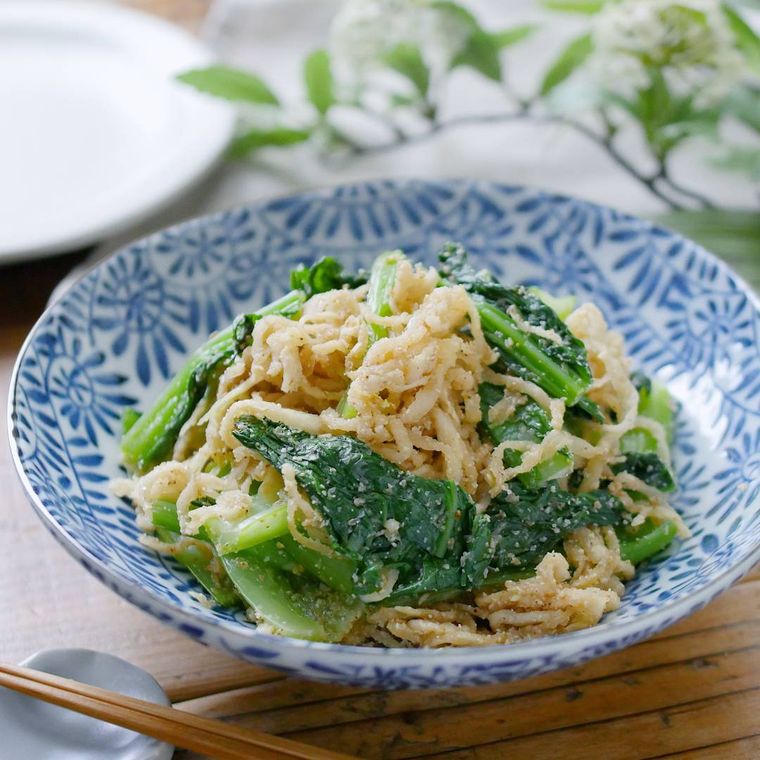 青い模様入りの皿に盛られた切り干し大根と小松菜のごま和え