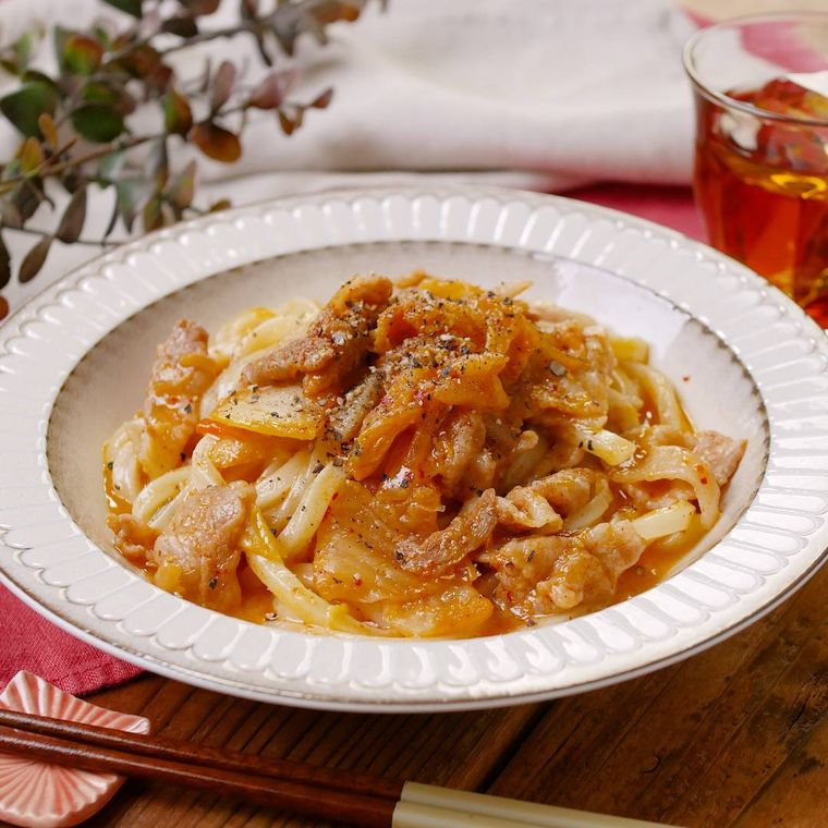 白い丸皿に盛り付けた豚キムカルボうどん