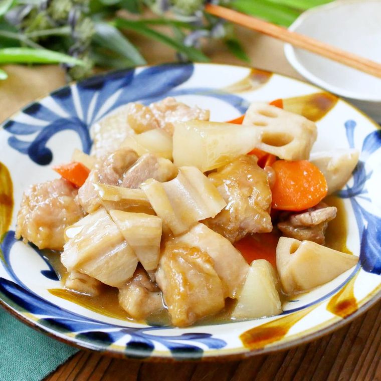 青と茶色の器に鶏もも肉と根菜の照り煮が盛られている様子