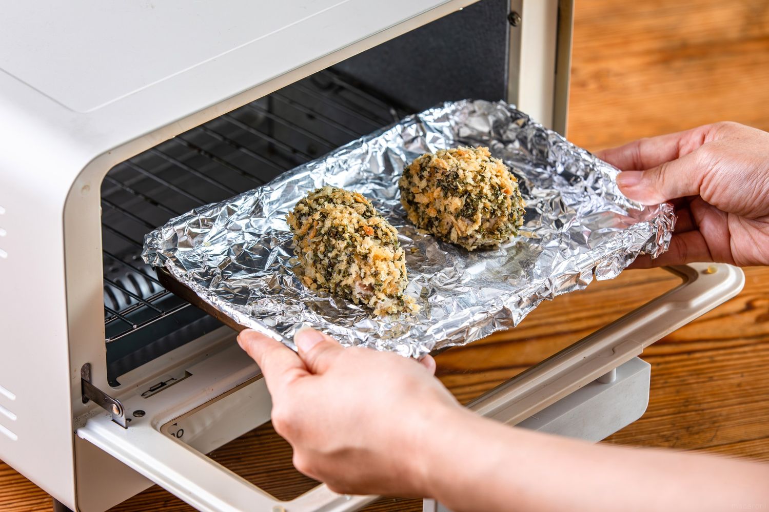 トースターに鯖のフライを入れている