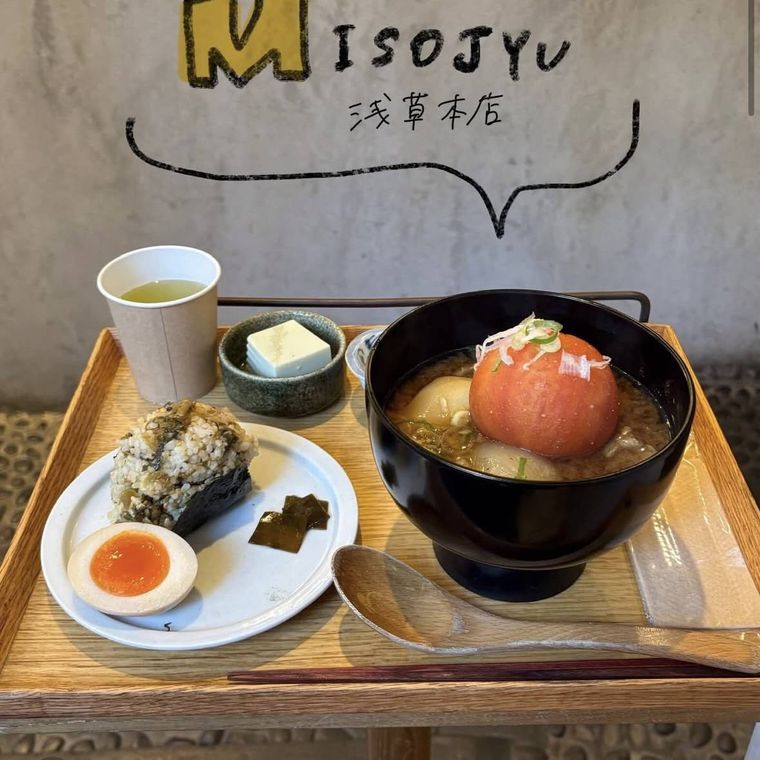 木のトレーに、おにぎり・汁もの・小鉢がのったセット