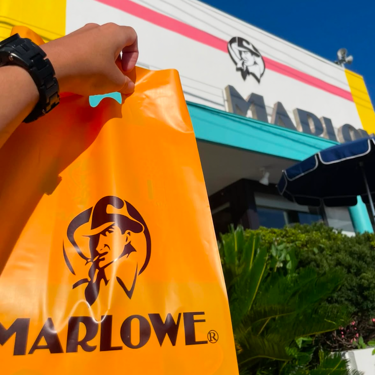 黄色とエメラルドグリーンが目立つ、マーロウ秋谷本店の外観