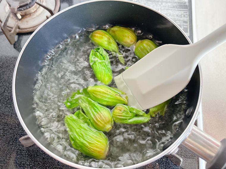 ふきのとうを塩を入れた熱湯でゆでる様子