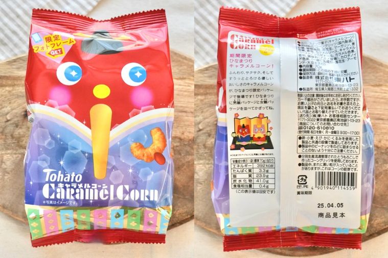 白いテーブルクロスと木のカッティングボードと白い皿にのったひなまつりパッケージのキャラメル味のコーンスナック