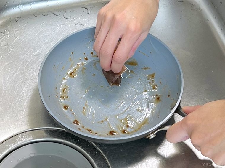 フライパンの油汚れをティーバッグで拭いている様子