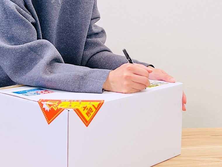 郵便物の宛名シールをマジックで塗りつぶしている様子