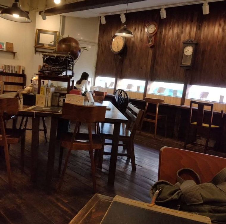 本が並び、テーブル席やカウンター席のある「カフェ青山文庫-本と珈琲とインクの匂い-」の店内