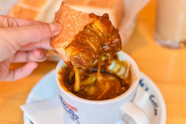 カレーを付けたトーストを持っているところ