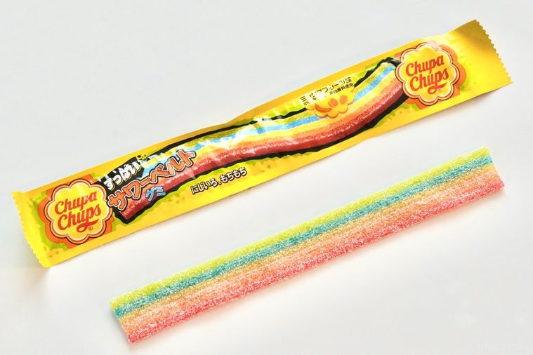 白い背景とレインボーのカラフルなベルトグミの黄色いパッケージ