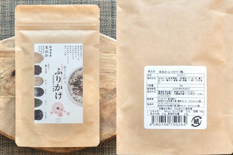茶色いテーブルクロスと木のカッティングボードにのった茶色い袋の米ぬかふりかけとパッケージ裏の成分表示