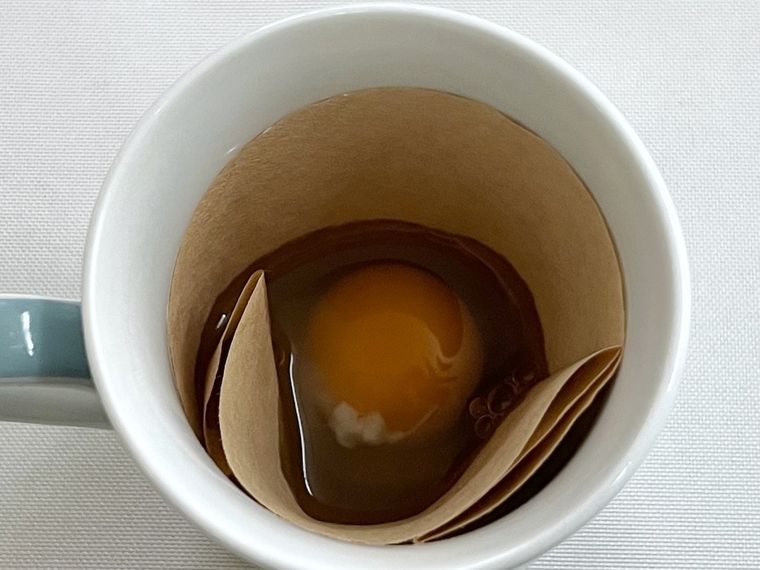 コーヒーフィルターに卵を割り入れた様子