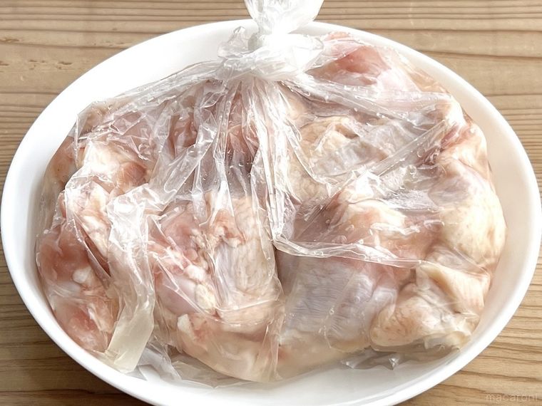 鶏手羽元を調味液に浸け込んでいる様子