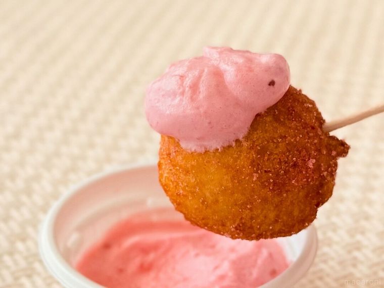 丸亀うどーなつ いちごみるく味にディップソースをつけている様子