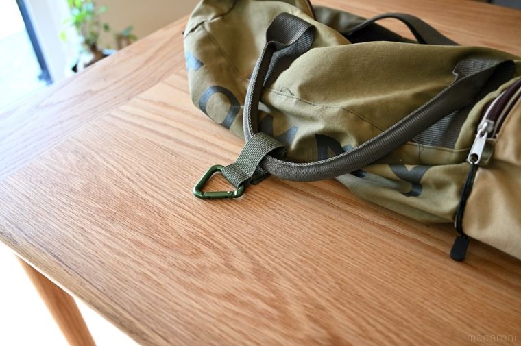 グリーンの旅行バッグにカラビナを取り付けた