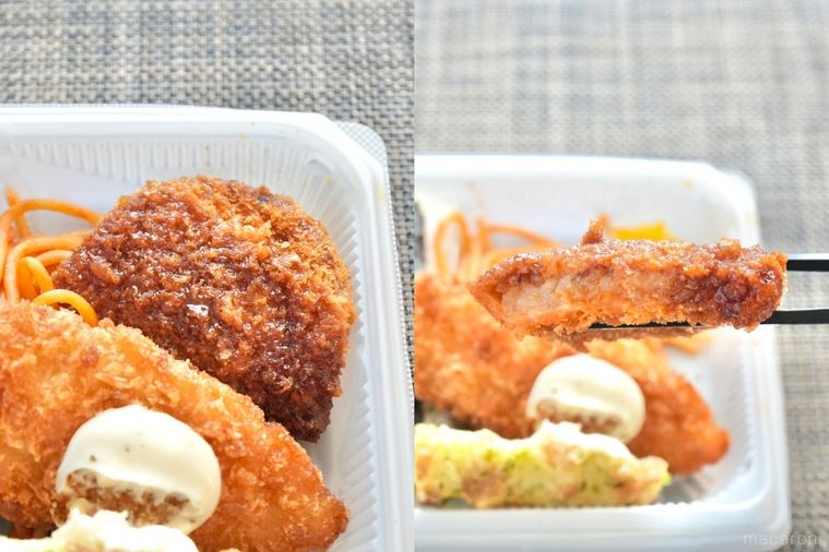 白い容器ののり弁とソースのかかった野菜コロッケを黒い箸で持つ様子