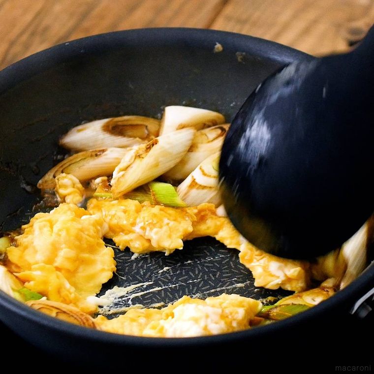 フライパンで卵と長ねぎを炒めている様子