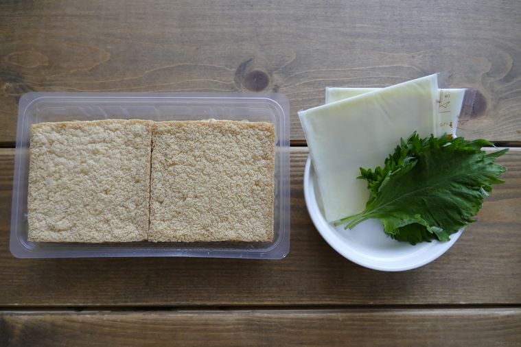 厚揚げ、スライスチーズ、大葉が並ぶ木製テーブル