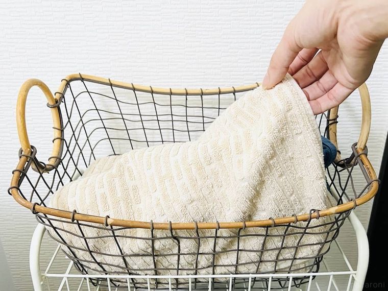 カゴからフェイスタオルを取り出している様子