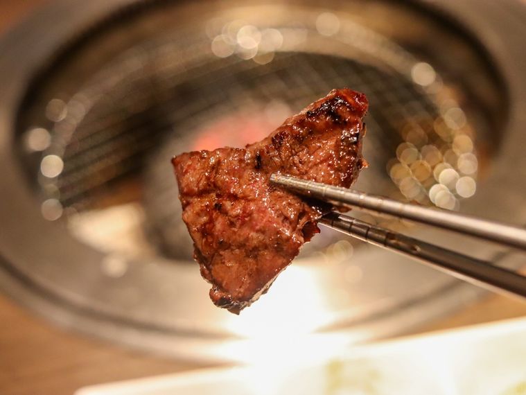 牛角ハラミを箸上げしている