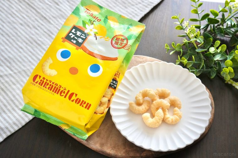 木のカッティングボードと白い皿にのった瀬戸内レモンケーキ味のキャラメルコーンと袋