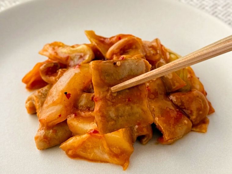 セブンプレミアム 旨辛コプチャンの肉を箸で持っている様子