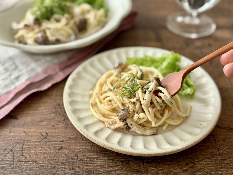 白い器に取り分けたツナパスタサラダを食べる様子