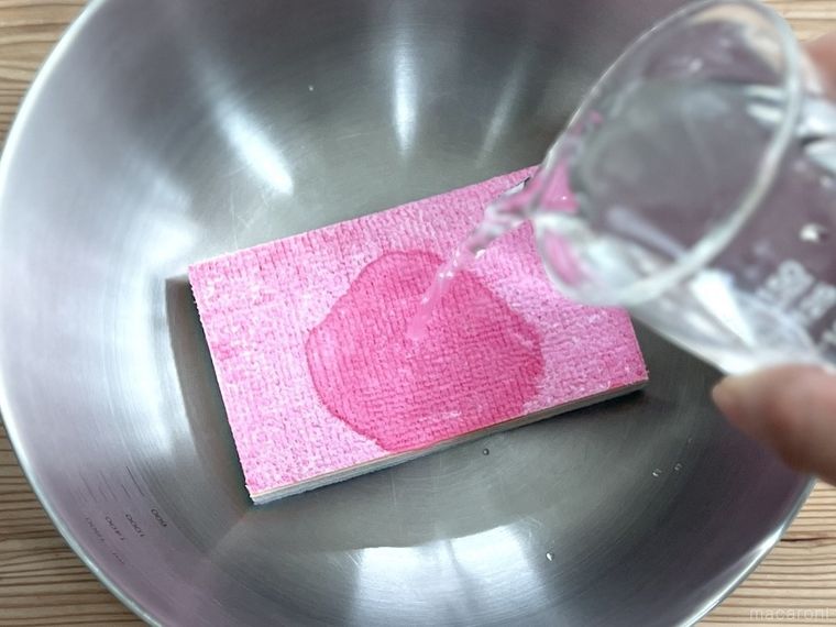 驚吸水おそうじスポンジに水をかけている様子