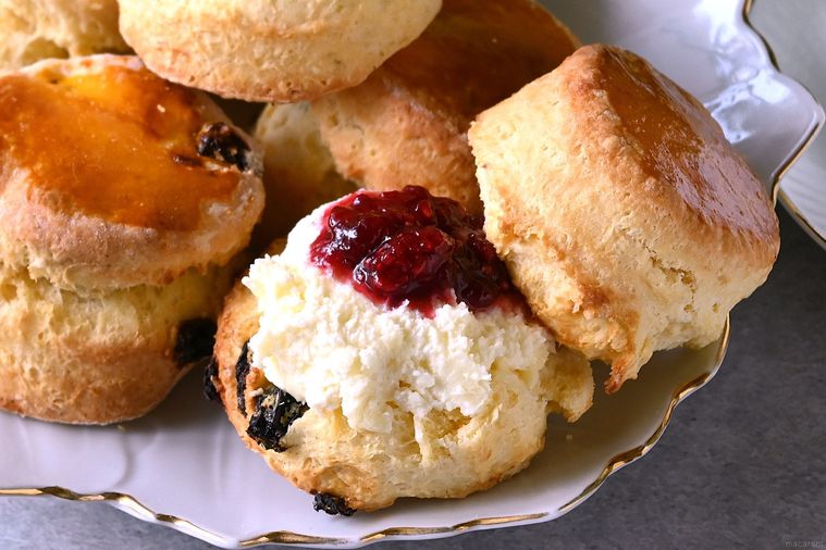 皿に盛り付けられたスコーンにクリームやジャムがのせてある