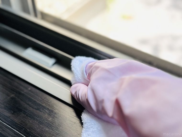 粗品タオルで窓の桟を拭いている様子