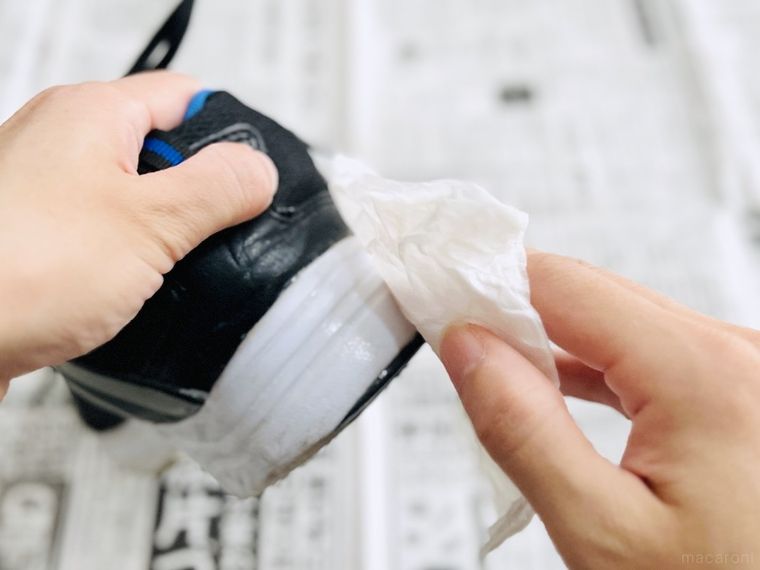 靴についた歯磨き粉をティッシュで拭き取っている様子