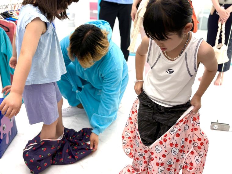 レインコートに着替える子どもたち